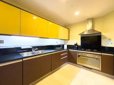 a large kitchen with brown cabinets and a sink at Luxury 2BR plus Maidrm at Grandeur Res Palm Jumeir in Dubai