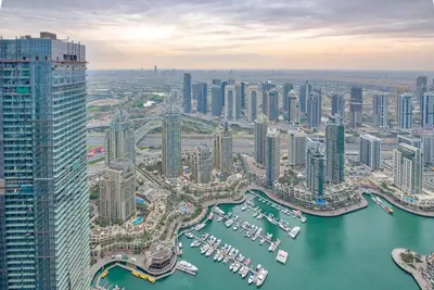 an aerial view of a city with boats in the water at 65th Floor Penthouse Dubai Marina in Dubai