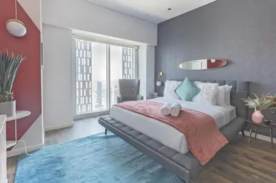 a bedroom with a large bed and a large window at 65th Floor Penthouse Dubai Marina in Dubai
