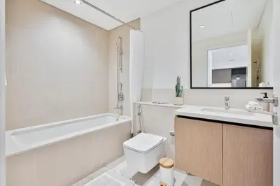 a bathroom with a tub and a toilet and a sink at Venetian - Wake up to Burj Khalifa views in Downtown Dubai in Dubai