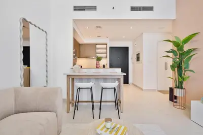 a kitchen and living room with a couch and a table at Venetian - Wake up to Burj Khalifa views in Downtown Dubai in Dubai
