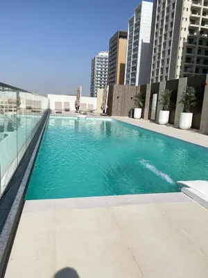 a large swimming pool on top of a building at Modern & Cozy 1 Bedroom Apartment in JVC 215-GLX-1 in Dubai