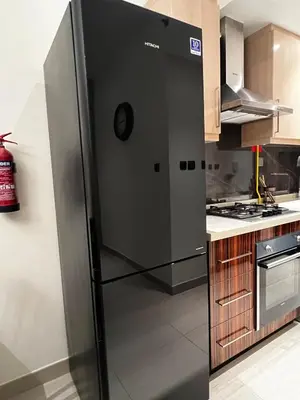 a stainless steel refrigerator in a kitchen at Burj View Elite Studio Apartment in Dubai