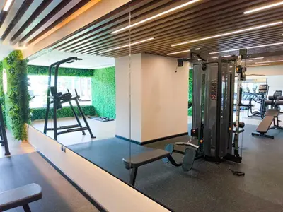 a gym with tread machines and a glass wall at Burj View Elite Studio Apartment in Dubai