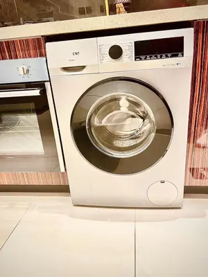 a washing machine sitting next to a microwave at Burj View Elite Studio Apartment in Dubai