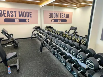 a gym with rows of dumbbells in a room at Burj View Elite Studio Apartment in Dubai