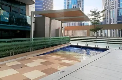 a pool in the middle of a building at Stylish 1br Merano Tower Pool Parking in Dubai
