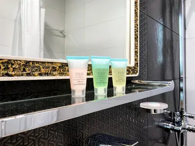 three cups sitting on a shelf in a bathroom at Stylish 1-Bedroom-Sleeps 4- Apartment -Bayz by Danube, Business Bay-29 in Dubai