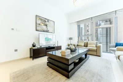 a living room with a couch and a table at FAM Living Act Two 1BR Walk to Burj & Dubai Mall in Dubai