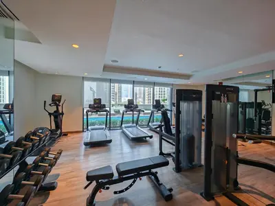a gym with treadmills and exercise equipment in a building at FAM Living Act Two 1BR Walk to Burj & Dubai Mall in Dubai