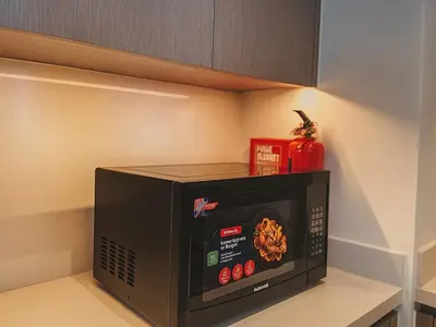 a microwave oven sitting on a shelf in a kitchen at Dream Shoma Upscale 3BR in Downtown Dubai in Dubai