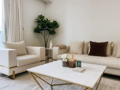 a living room with a couch and a coffee table at Dream Shoma Upscale 3BR in Downtown Dubai in Dubai
