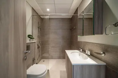 a bathroom with a sink and a toilet and a mirror at Luxury unit in the Heart of Dubai Hills in Dubai