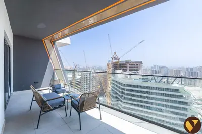a balcony with two chairs and a large window at Vogue Al Jadaf Binghatti Creek near Festival Mall, Three Bedroom Apartment with Balcony and City View, Access to all Amenities in Dubai