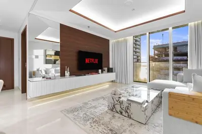 a living room with a tv on a wall at Romantic basic apertmen in Dubai