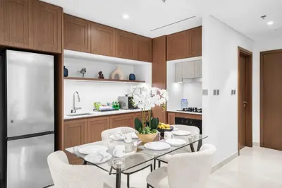 a kitchen with a dining table with white chairs at Romantic basic apertmen in Dubai