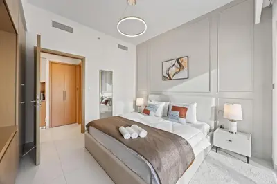 a bedroom with a large bed in a room at Dreamy Apartment,Pool with Burj khalifa View ,5Min Walk to Dubai Mall in Dubai