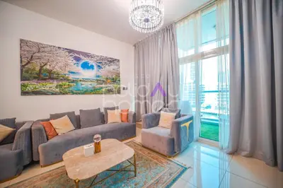 a living room with a couch and a table at Stylish 2BR in Continental Tower Dubai Marina in Dubai