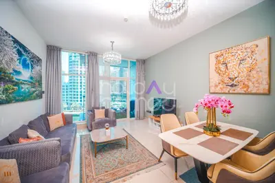 a living room with a table and chairs at Stylish 2BR in Continental Tower Dubai Marina in Dubai