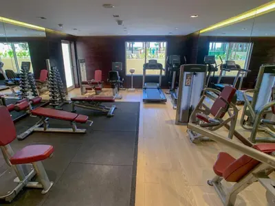 a gym with a bunch of treadmills and machines at Vacationer I JVC Gem 1 Bedroom I Free Pool, Gym, Parking & Wi-Fi in Dubai