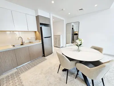 a kitchen with a table and chairs in a room at SUNRISE HOMES - Stylish 1-BR with Incredible Views - Creekside in Dubai