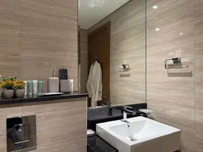 a bathroom with a white sink and a mirror at Cozy Studio with Balcony Pool View - Business Bay in Dubai