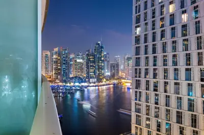 a view of a city at night from a building at Luxury Apartment 2BR with Sea & Palm View - DAMAC Heights in Dubai