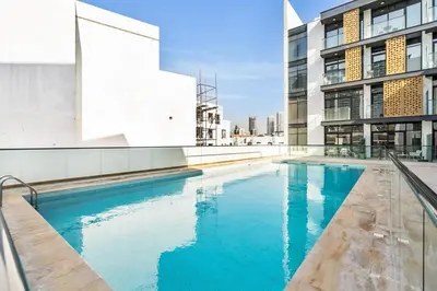 a swimming pool on the side of a building at DAYF-SER08 Brand New Studio with Balcony in JVC in Dubai