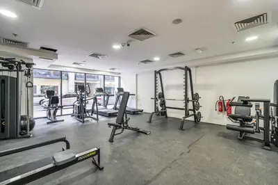 a gym with several treadmills and machines at DAYF-SER08 Brand New Studio with Balcony in JVC in Dubai