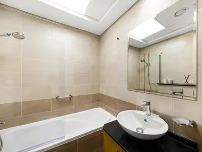 a bathroom with a sink and a bath tub at Amazing Design Colorfull Flat Palm Jumeirah View in Heart of Marina in Dubai