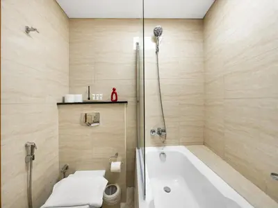 a bathroom with a tub and a toilet and a sink at Amazing Design Colorfull Flat Palm Jumeirah View in Heart of Marina in Dubai