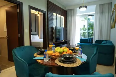 a living room with a table with fruit on it at Vera Tower - 2 Bedroom with Burj Khalifa view in Dubai