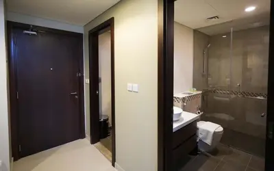 a bathroom with a toilet and a sink and a shower at Vera Tower - 2 Bedroom with Burj Khalifa view in Dubai