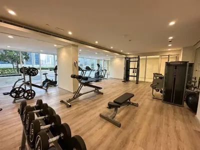 a gym with treadmills and exercise equipment in a room at Vera Tower - 2 Bedroom with Burj Khalifa view in Dubai