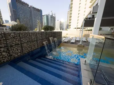 a swimming pool in the middle of a building at Vera Tower - 2 Bedroom with Burj Khalifa view in Dubai
