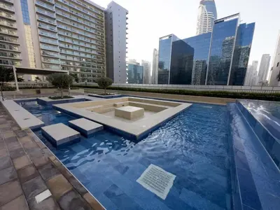 a swimming pool in a city with tall buildings at Vera Tower - 2 Bedroom with Burj Khalifa view in Dubai