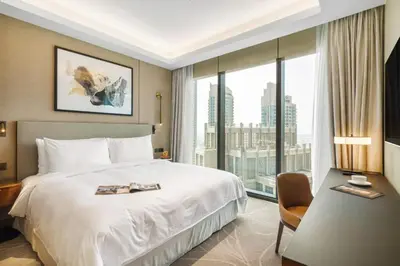 a hotel room with a bed and a large window at Address Opera - Ultra luxurious 2BDR in Downtown in Dubai