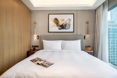 a hotel room with a bed with a magazine on it at Address Opera - Ultra luxurious 2BDR in Downtown in Dubai