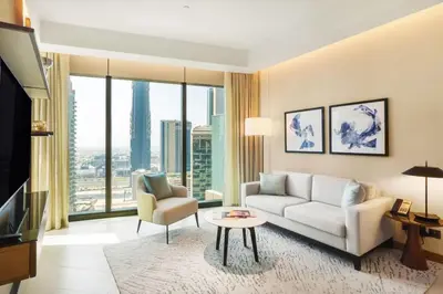 a living room with a couch and a tv at Address Opera - Ultra luxurious 2BDR in Downtown in Dubai