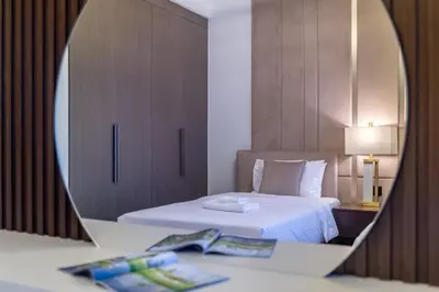 a mirror reflection of a bedroom with a bed at The 34th Perch Downtown Retreat 2BDR in Dubai