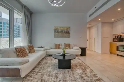 a living room with a couch and a table at LA VIE 1BDR in JBR with Private Beach in Dubai