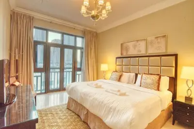 a bedroom with a large bed and a large window at Gorgeous 1BDR with Burj Khalifa & Fountain Views in Dubai