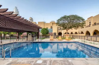 a swimming pool in the courtyard of a building at Gorgeous 1BDR with Burj Khalifa & Fountain Views in Dubai