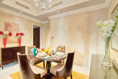 a dining room with a table and chairs at Gorgeous 1BDR with Burj Khalifa & Fountain Views in Dubai