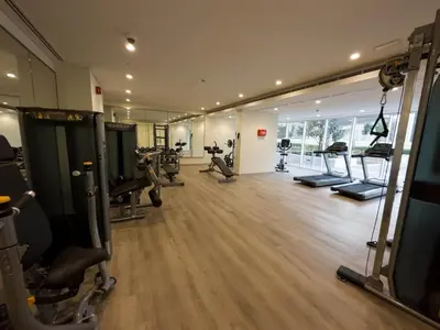 a gym with treadmills and machines in a room at Brand new 1BDR in Vera- Business Bay in Dubai