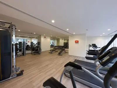 a gym with treadmills and cardio equipment in a building at Brand new 1BDR in Vera- Business Bay in Dubai