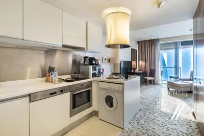 a kitchen with a washer and dryer in a room at Luxurious Studio Flat with Burj Khalifa Views in Dubai