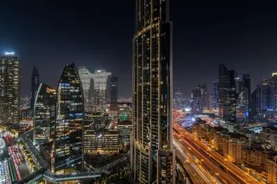 a view of a city at night with traffic at Luxurious Studio Flat with Burj Khalifa Views in Dubai