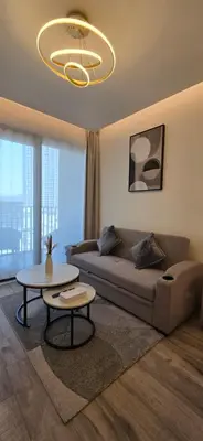 a living room with a couch and a table at Studio Apartment Near downtown Dubai in Dubai
