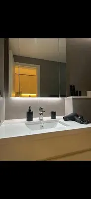 a bathroom with a sink and a mirror at Studio Apartment Near downtown Dubai in Dubai